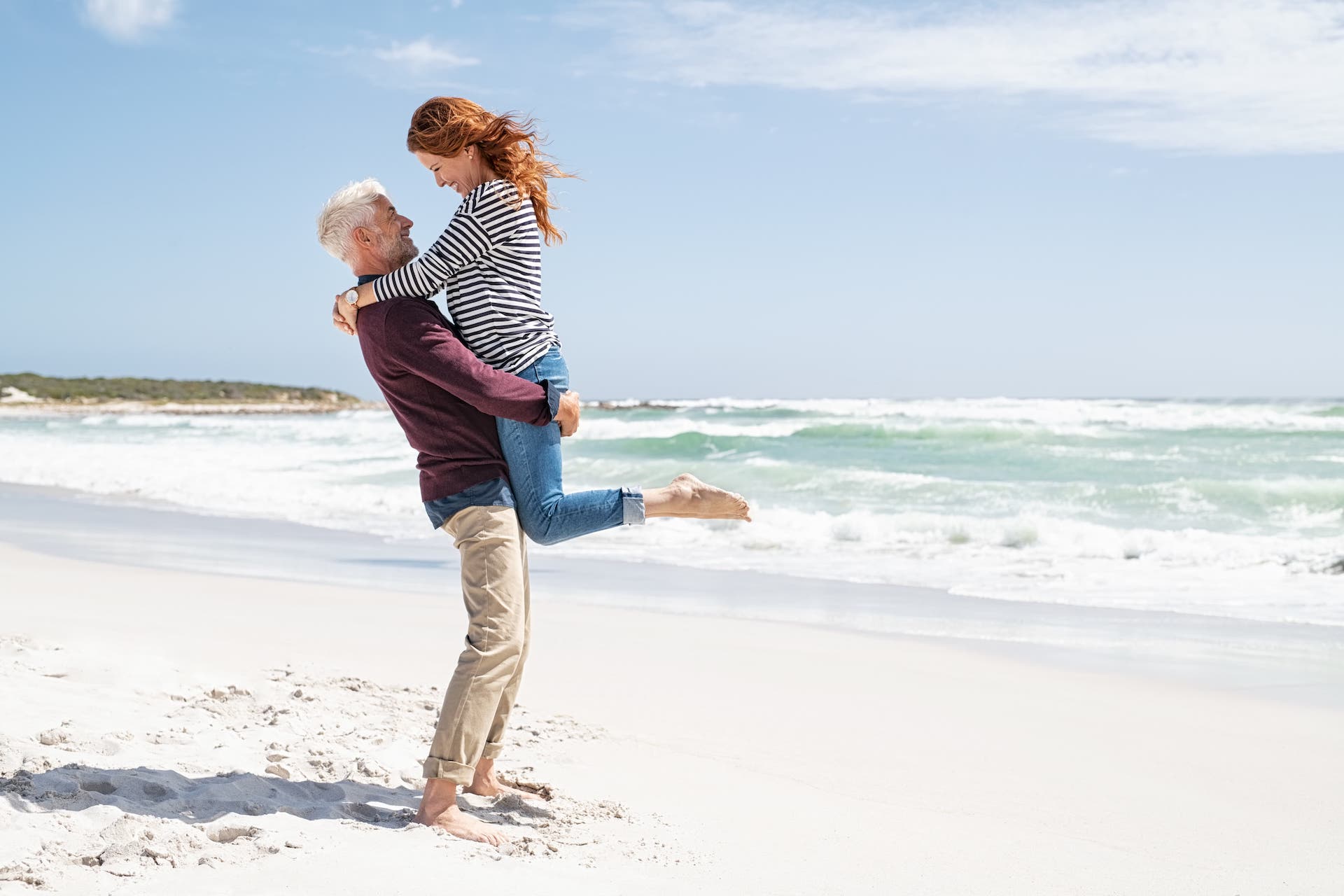 man and woman on a beach happy after vaginal rejuvenation surgery